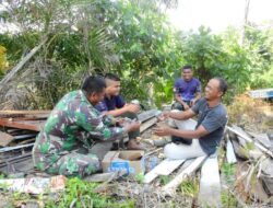 Di Sela-sela Istirahat, Anggota Satgas TMMD Bersenda Gurau Bersama Masyarakat