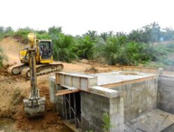 Anggota Satgas TMMD Awasi Penimbunan Tanah Mengunakan Excavator.